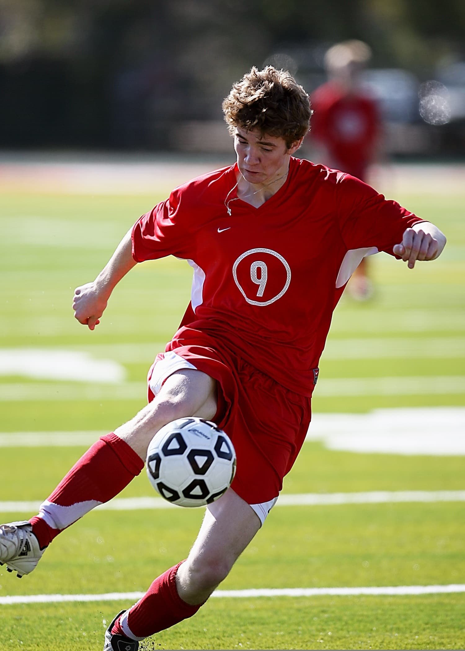 Youth football player kicking a ball
